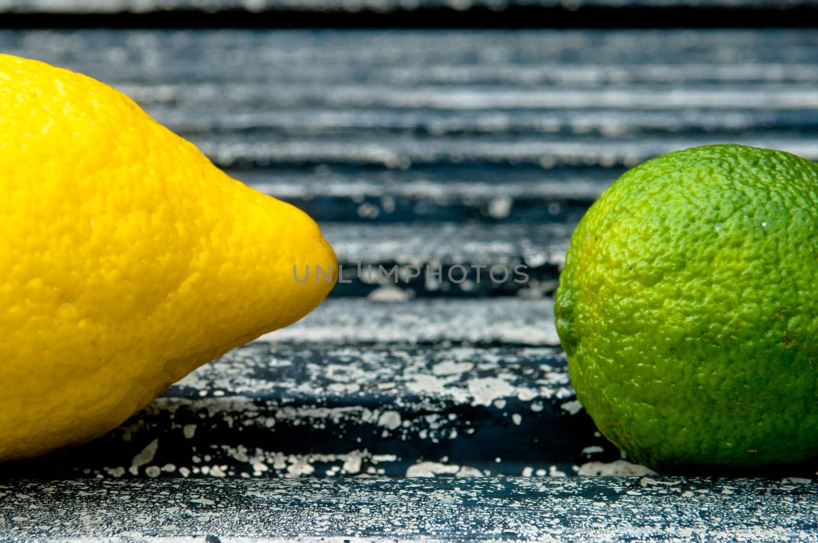 Raw textured black Background backdrop with lemon and lime and copy space outdoor