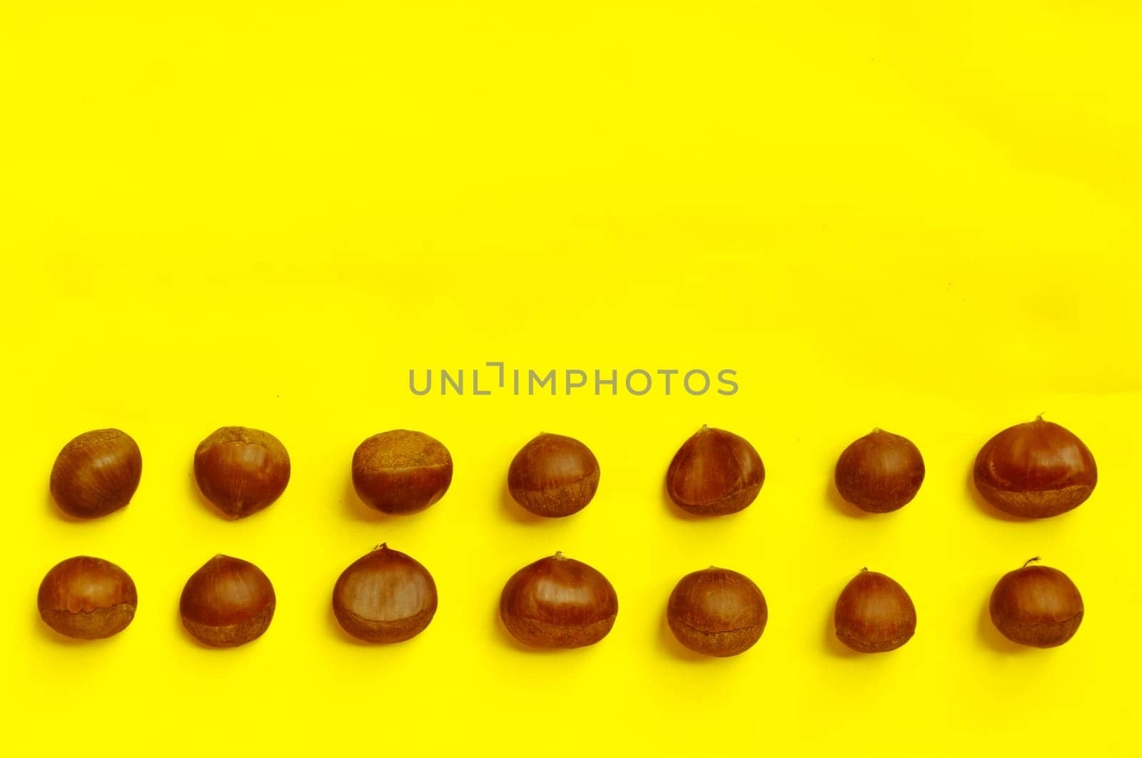 Chestnuts pattern on yellow background, top view, chestnut, castanea