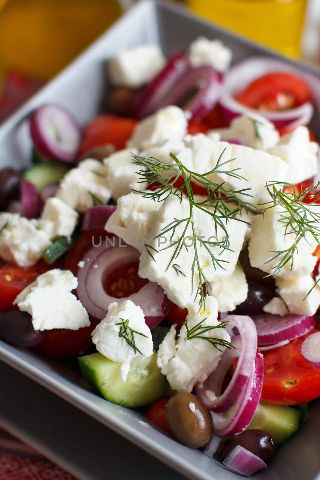 Greek salad with tomatoes, feta cheese, cucumbers, onions and olives