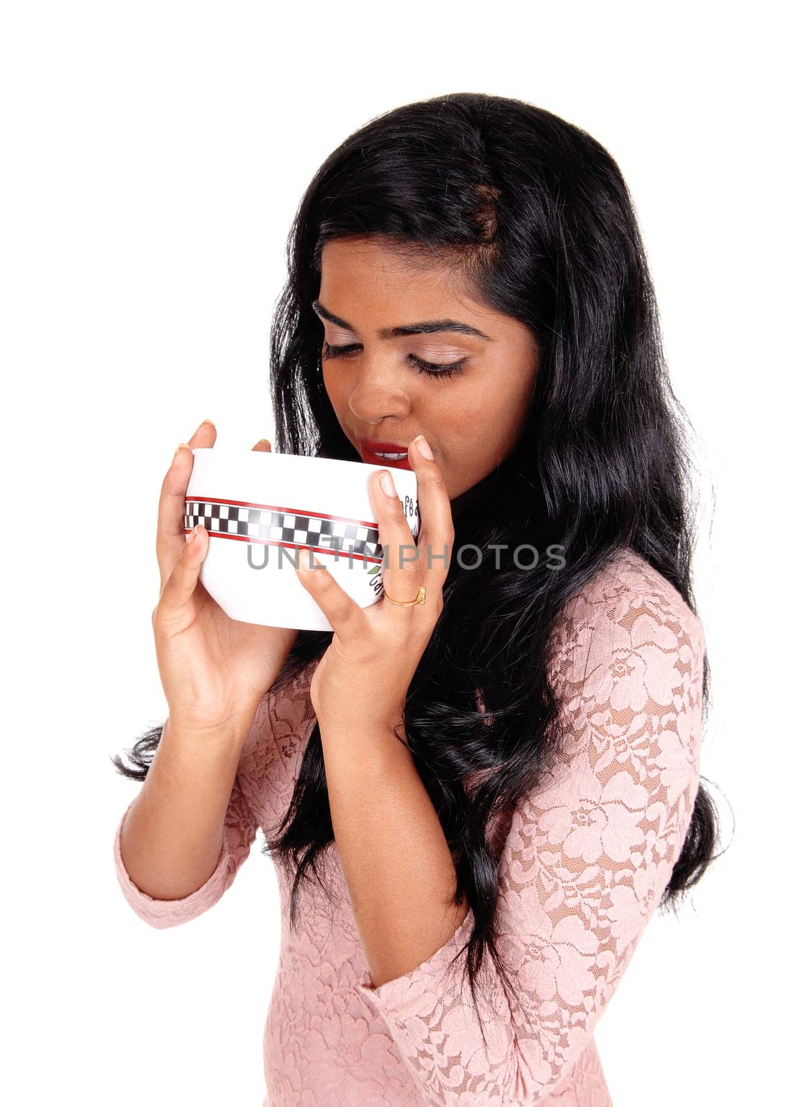 A lovely young Indian woman holding a big bowl to her mouth, with.long black hair, isolated for white background..