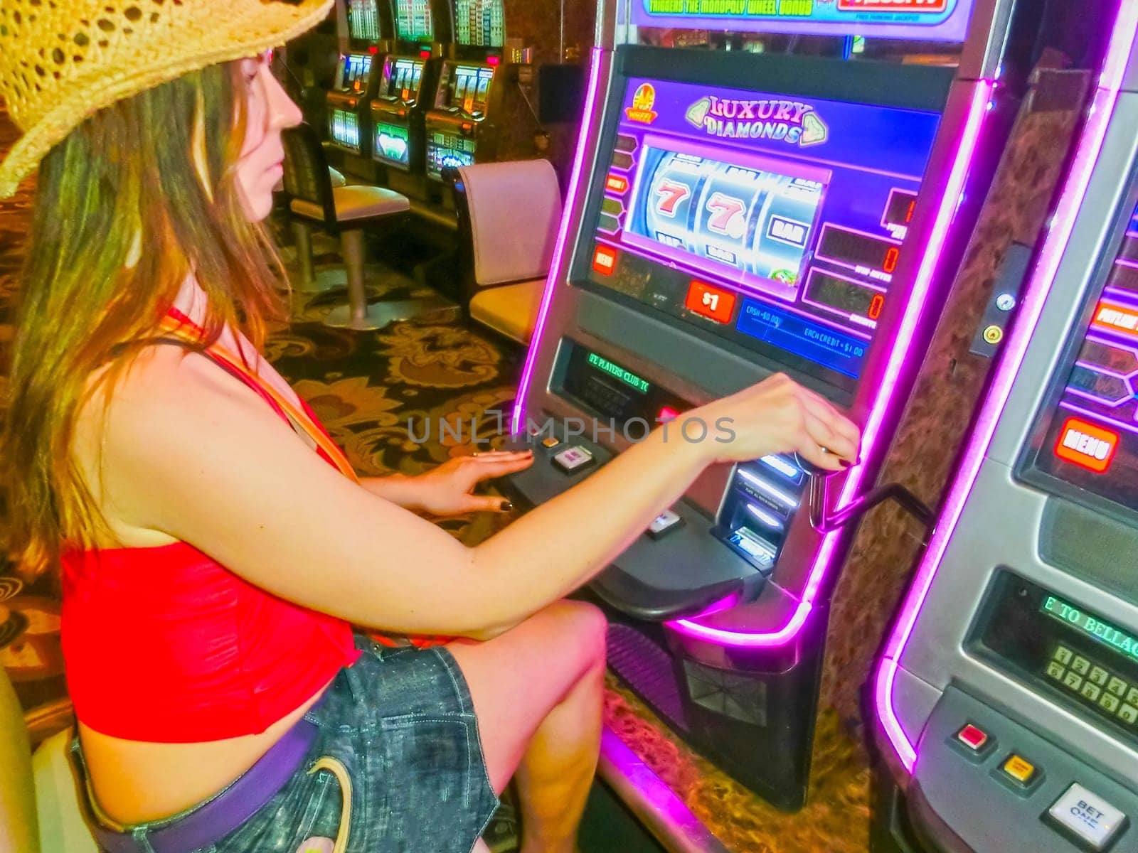 Las Vegas, United States of America - May 05, 2016: Concentrated girl playing slot machines in the Excalibur Hotel and Casino