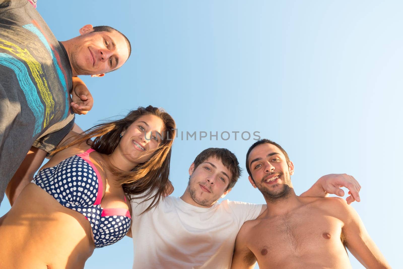 Group of happy teenage friends at the beach