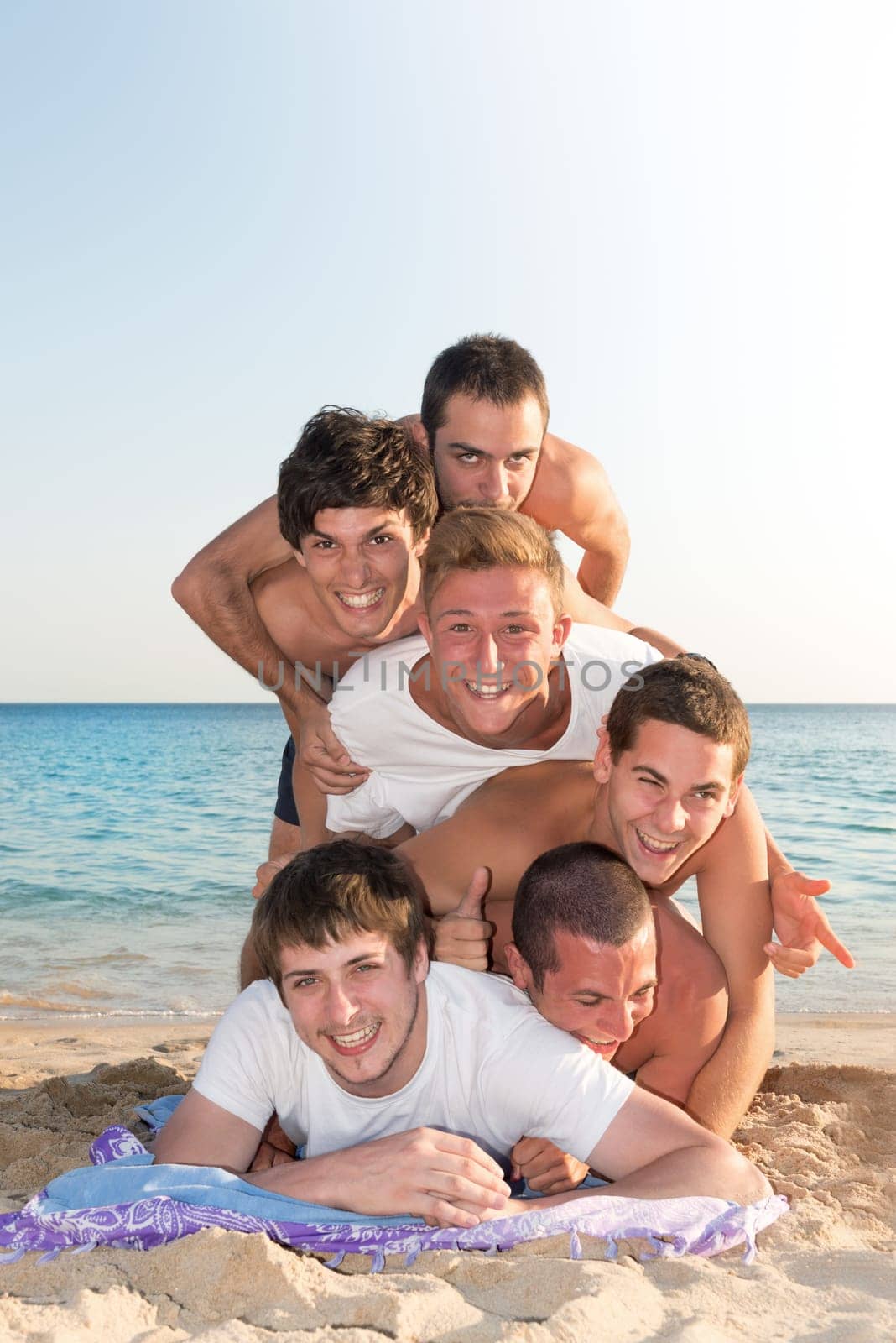 Group of happy teenage boys at the beach