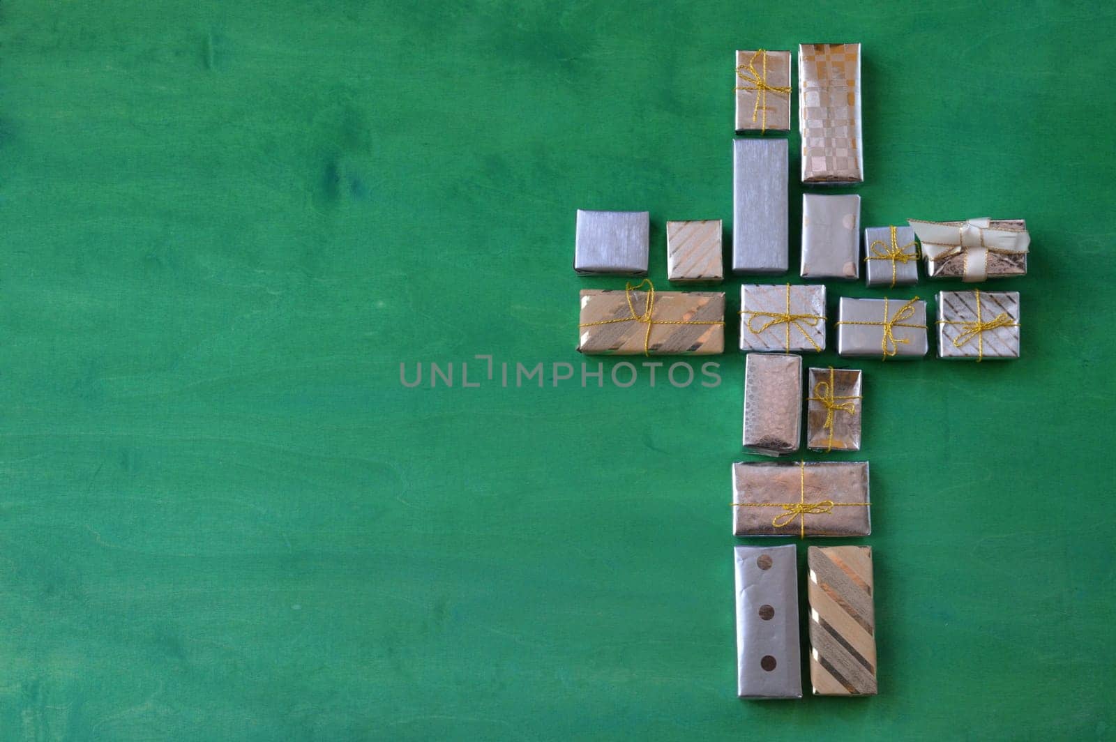 many small gifts on green wood form a cross