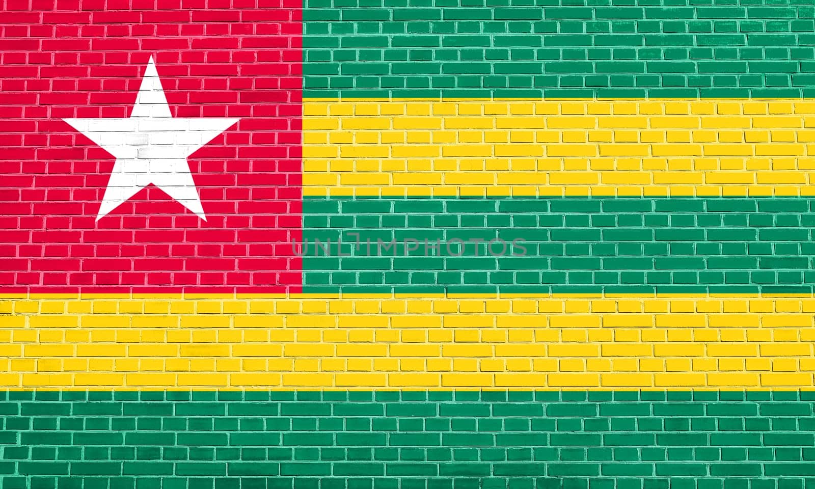 Togolese national official flag. African patriotic symbol, banner, element, background. Flag of Togo on brick wall texture background