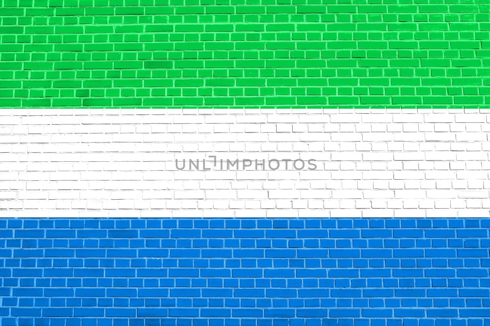 Sierra Leonean national official flag. African patriotic symbol, banner, element, background. Flag of Sierra Leone on brick wall texture background