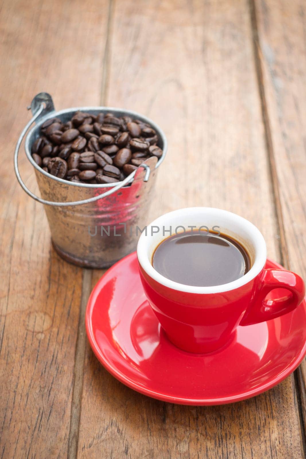 Red cup of espresso on wooden table, stock photo