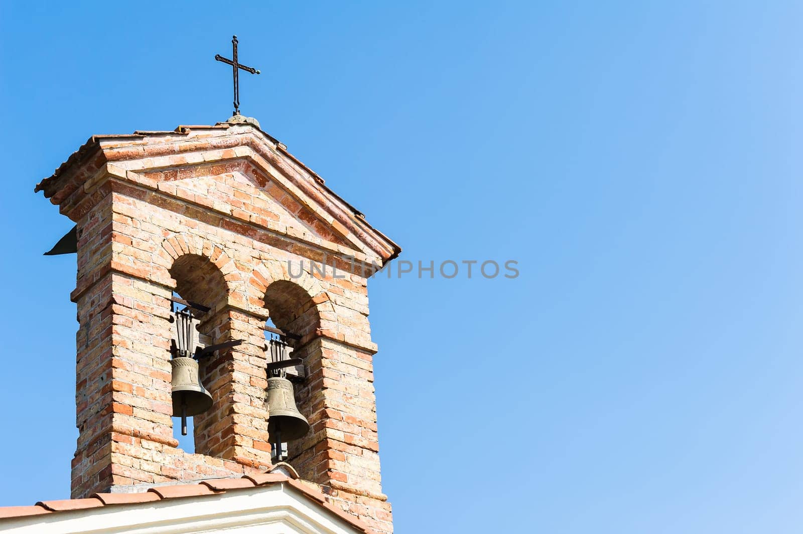 Small bell tower with a bell of a country church in the 14th century