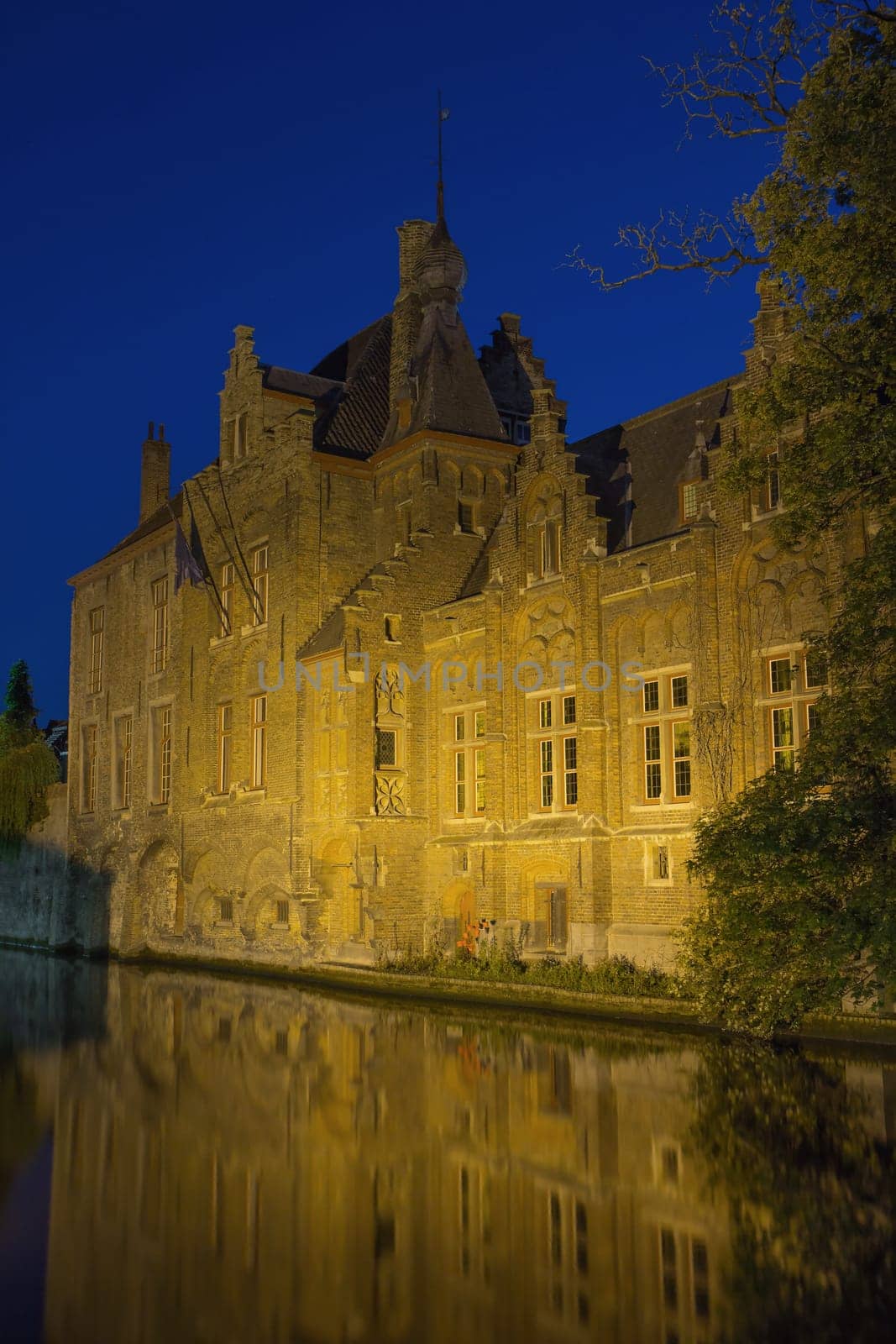 Historic houses along Dijver Canal in Bruges at night. (Belgium)