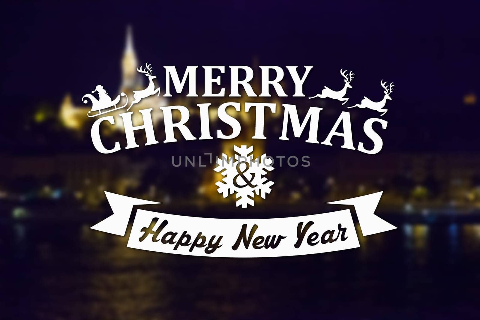 Merry Christmas and New Year greeting card on blurred night city illuminated old buildings with reflection in water background