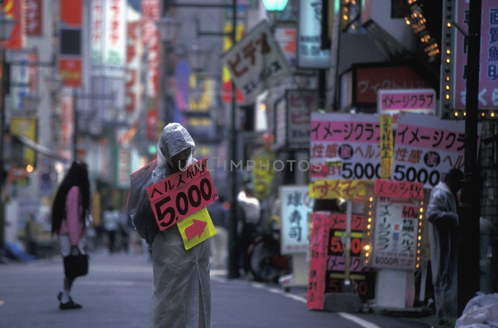 a streetworker in the city centre of Tokyo in Japan in Asia,....