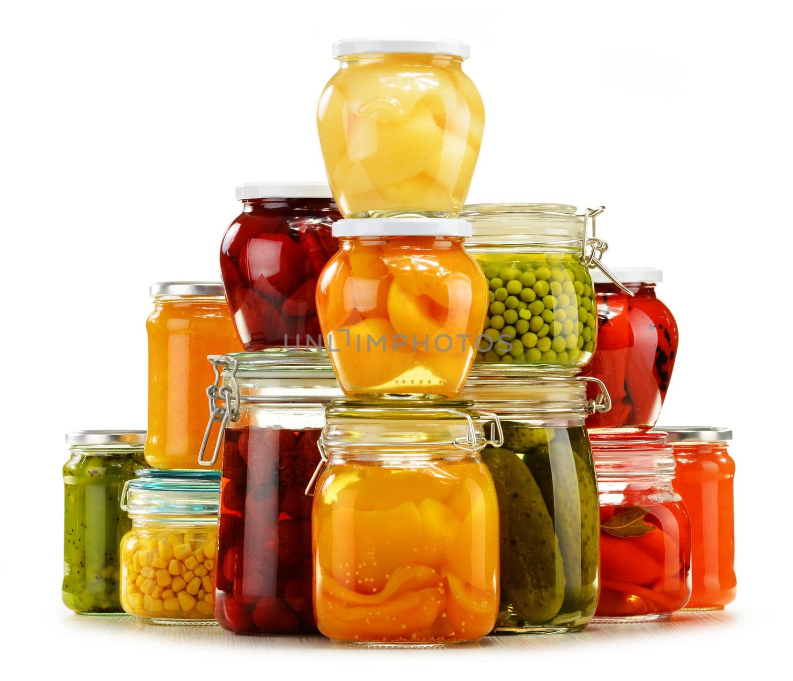 Jars with pickled vegetables, fruity compotes and jams isolated on white background. Preserved food