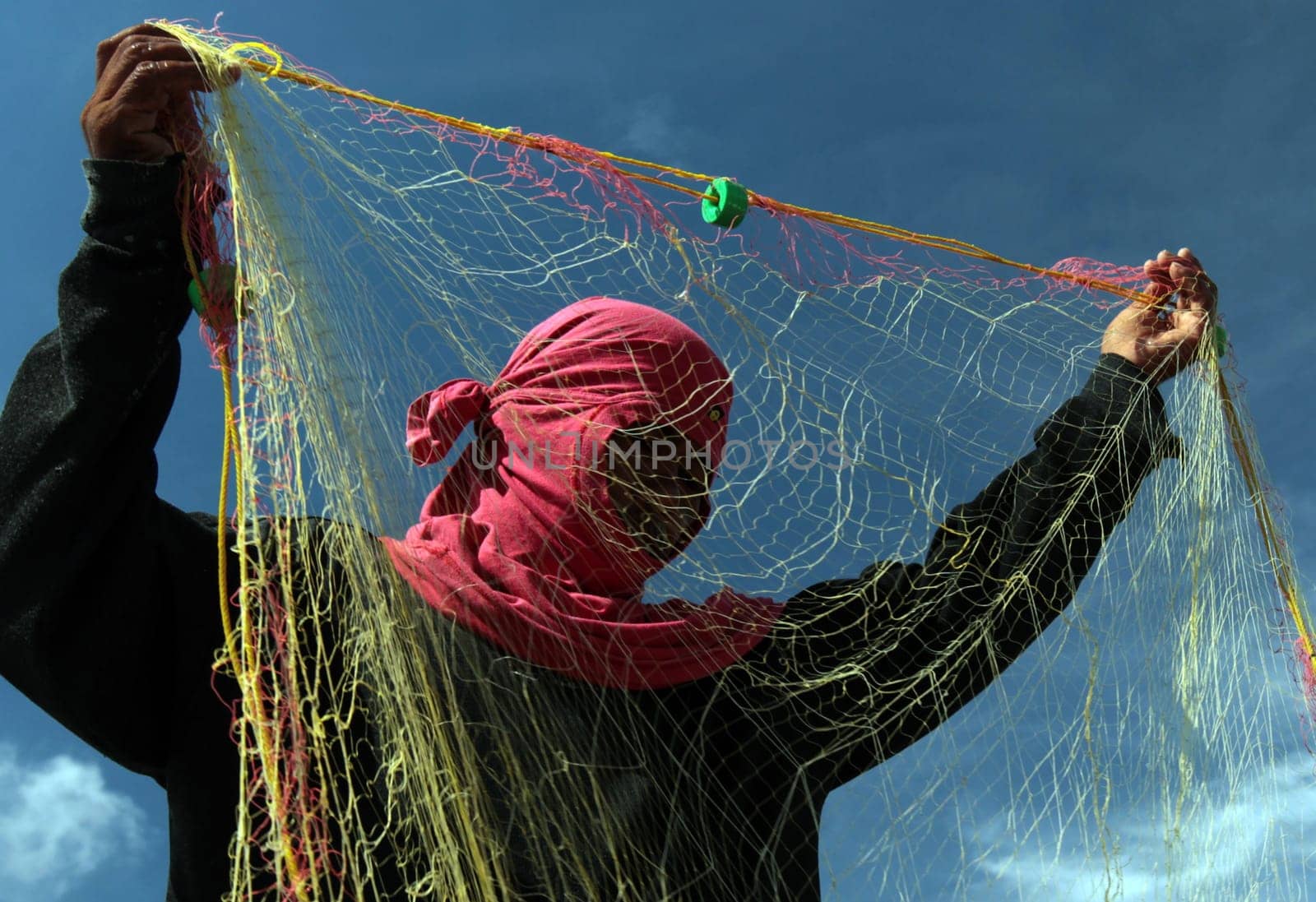 A fisherman in the water landscape around the capital Bandar Seri Begawan in the kingdom of Brunei Darussalam on Borneo in South East Asia.