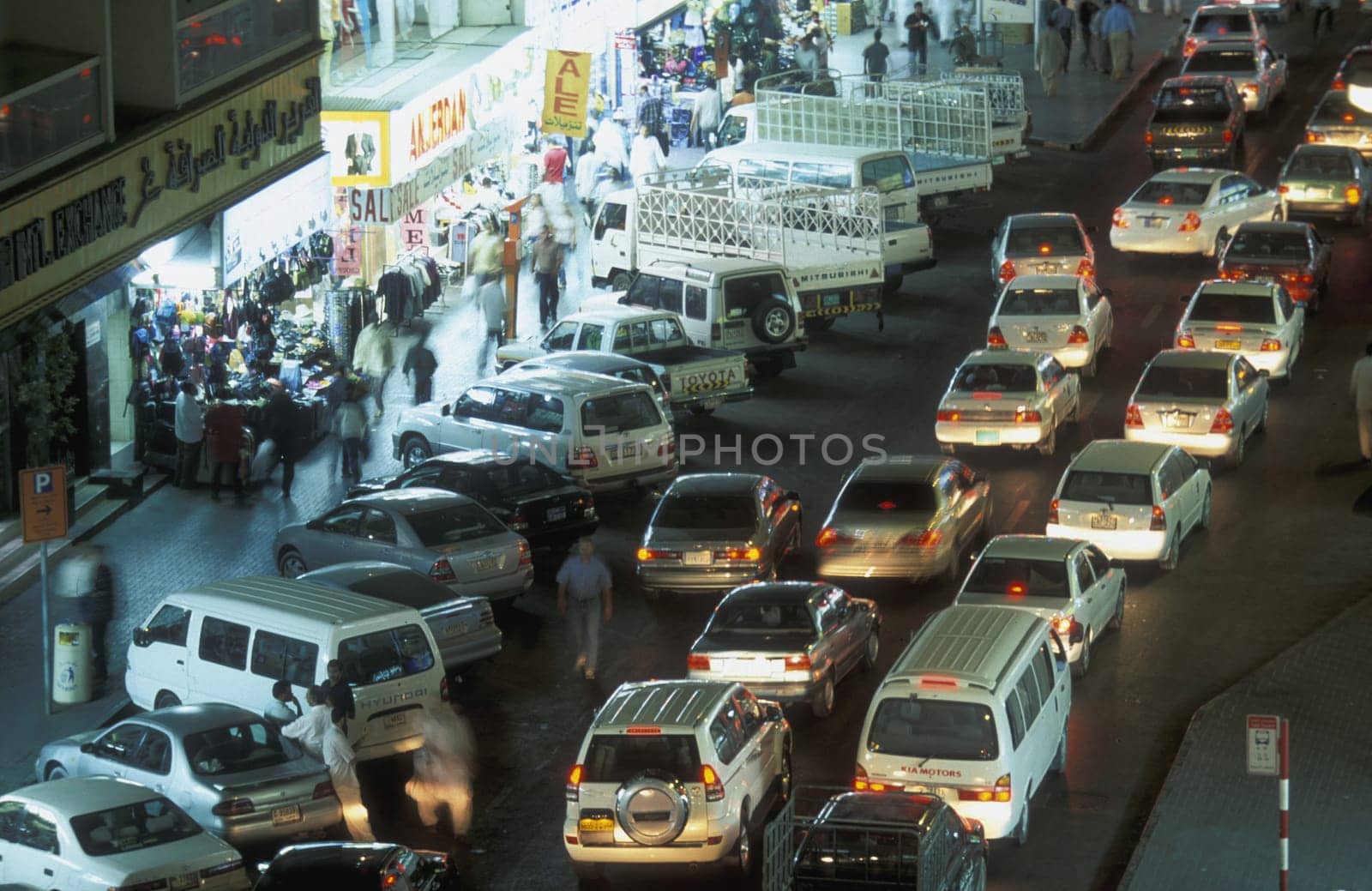 a road at night in the old town in the city of Dubai in the Arab Emirates in the Gulf of Arabia.