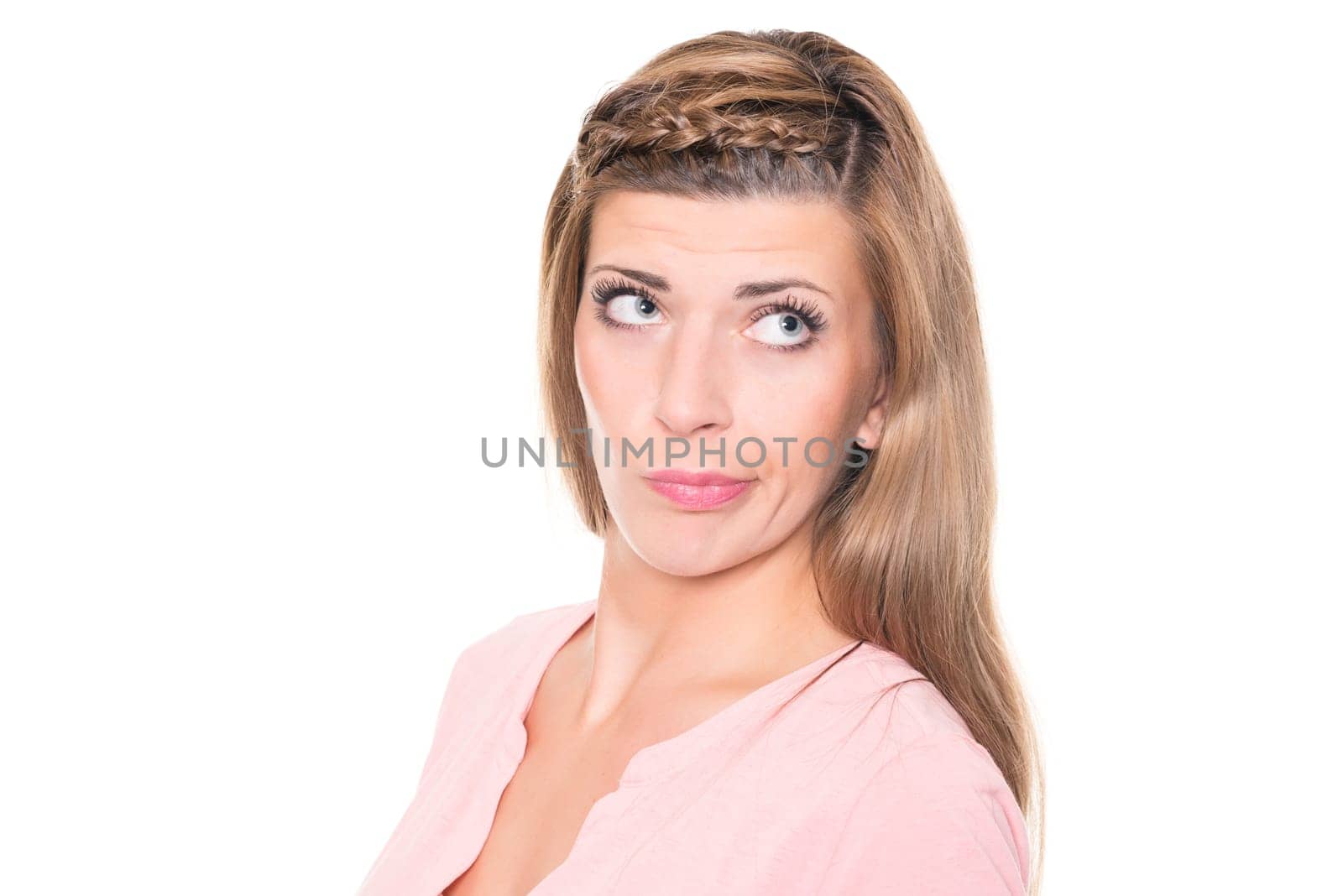 Astonished young woman against a white background