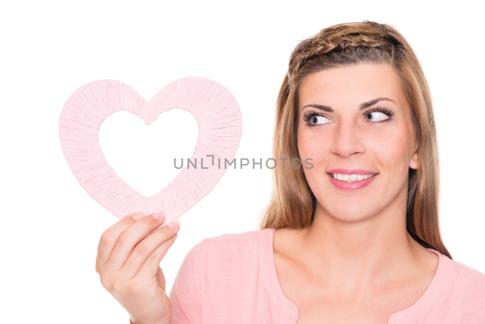 Portrait of a young woman with a pink heart against a white background