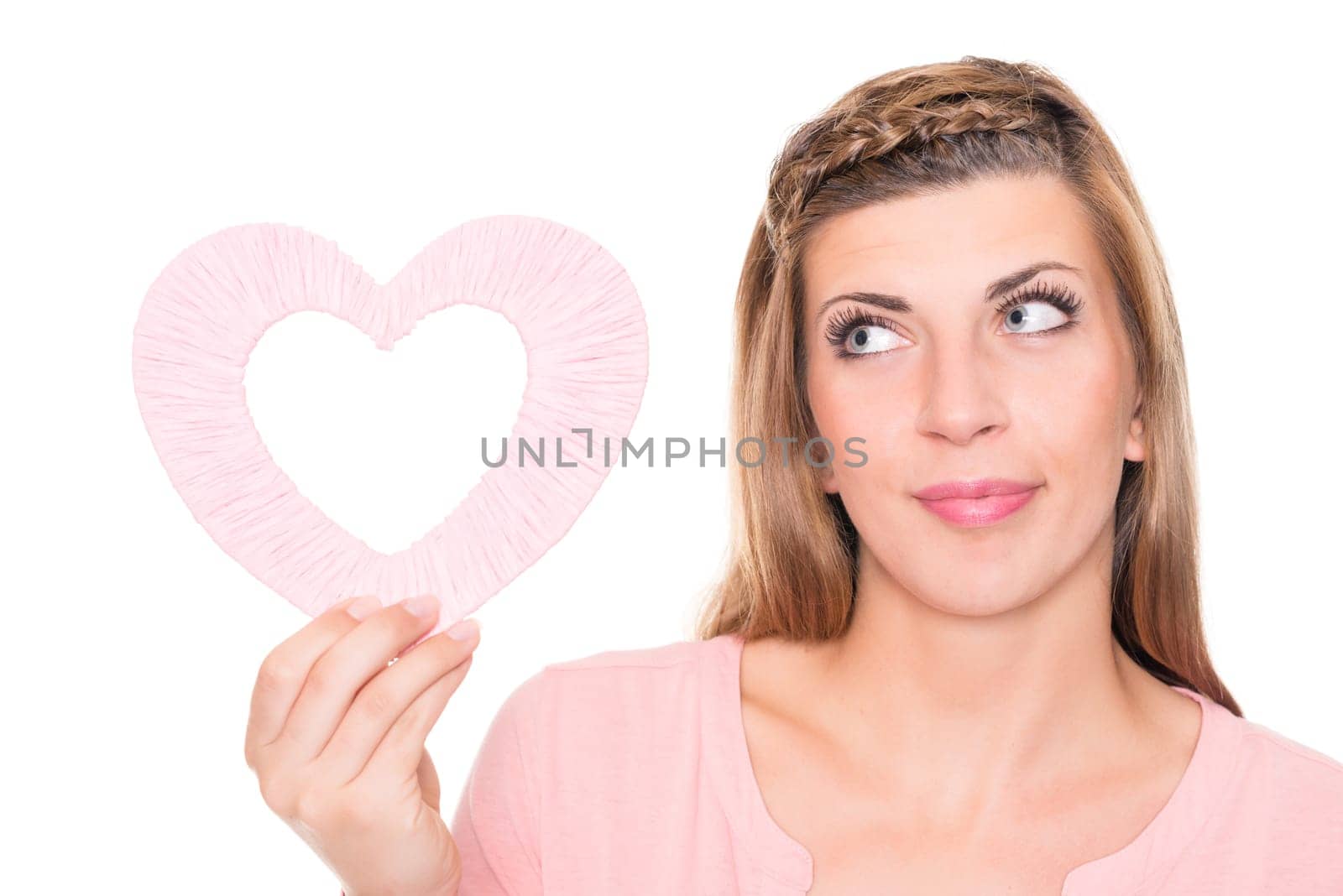 Portrait of a young woman with a pink heart against a white background