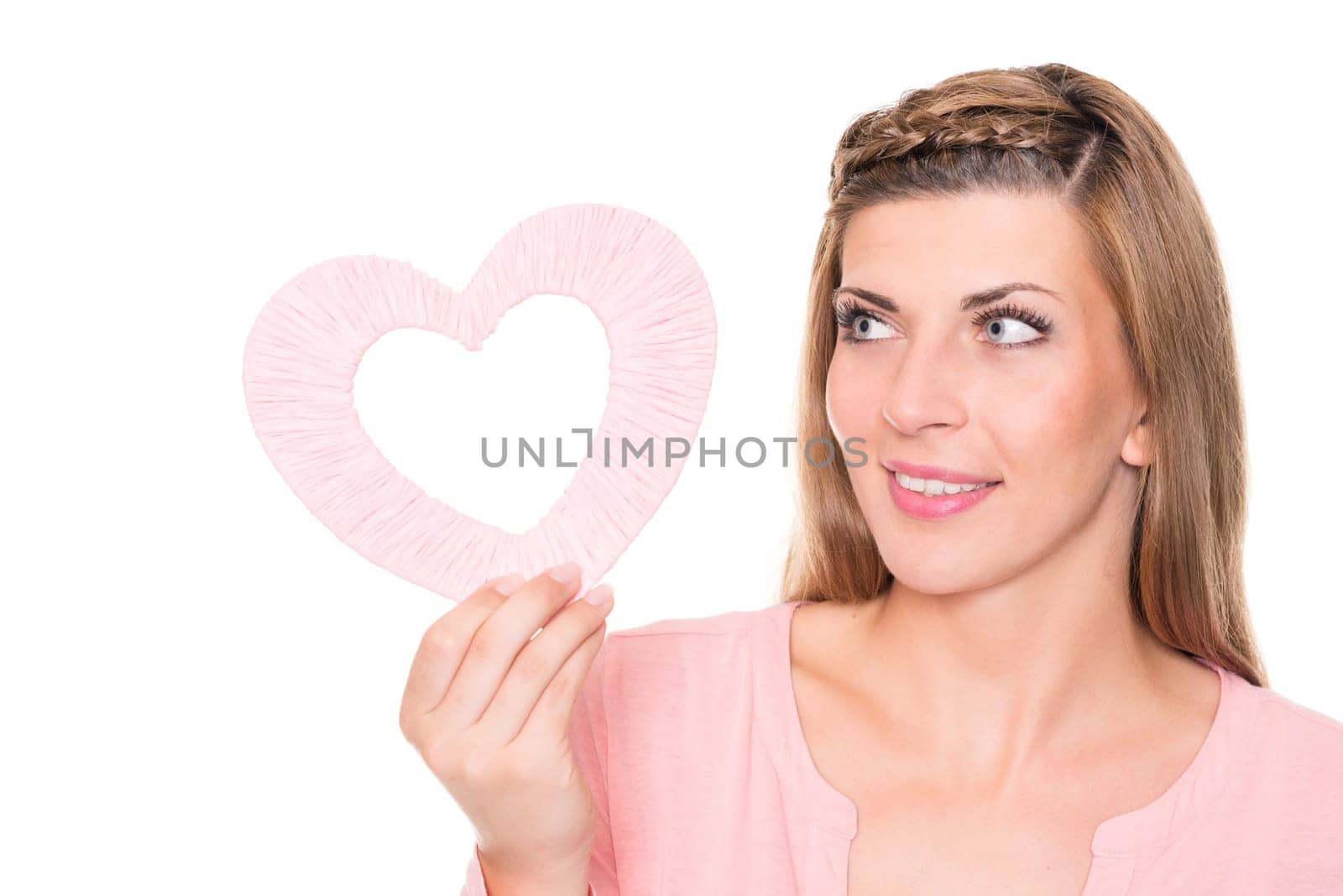 Portrait of a young woman with a pink heart against a white background