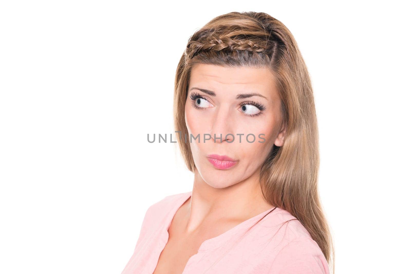 Astonished young woman against a white background