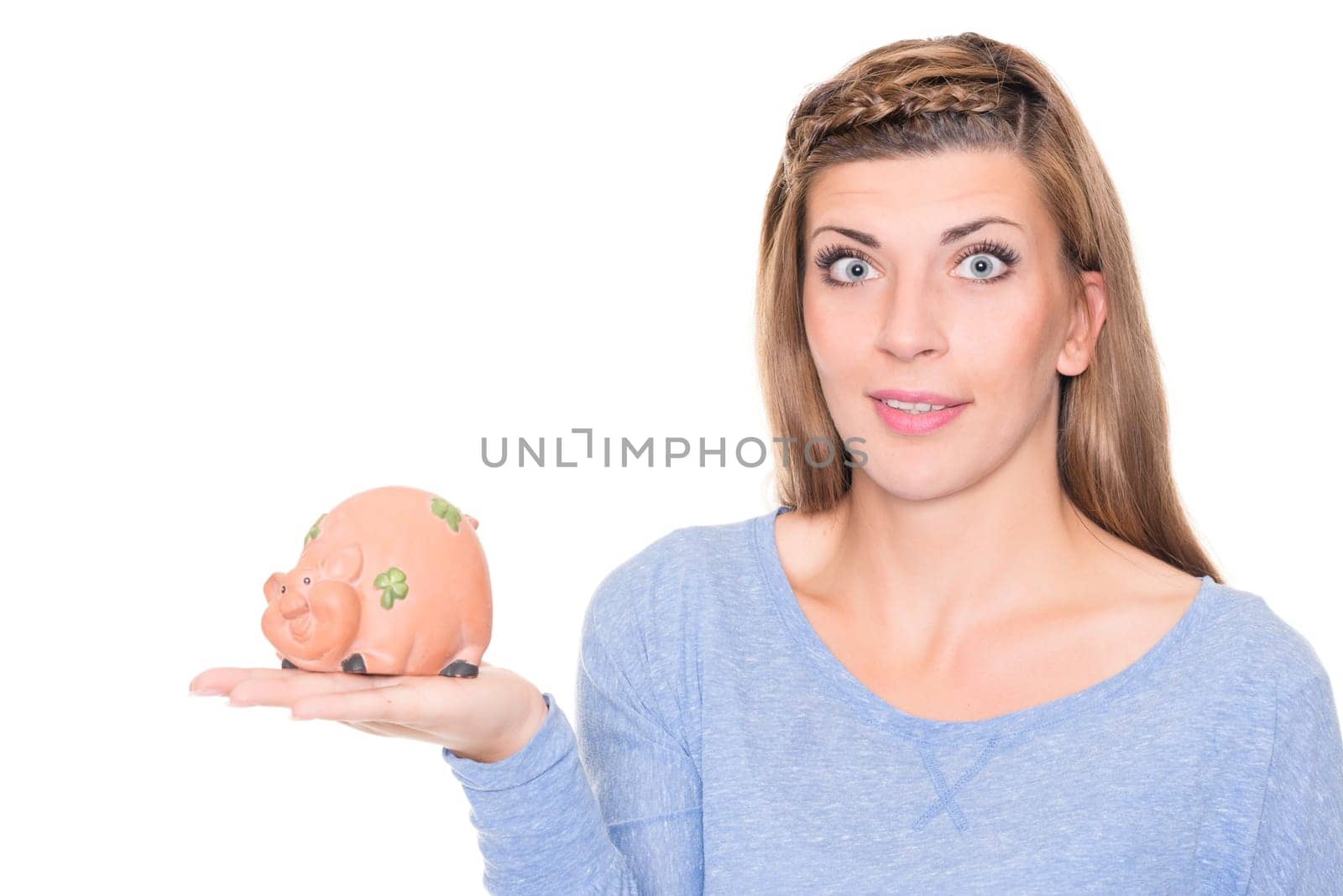 Portrait of a young woman with a piggy bank against a white background