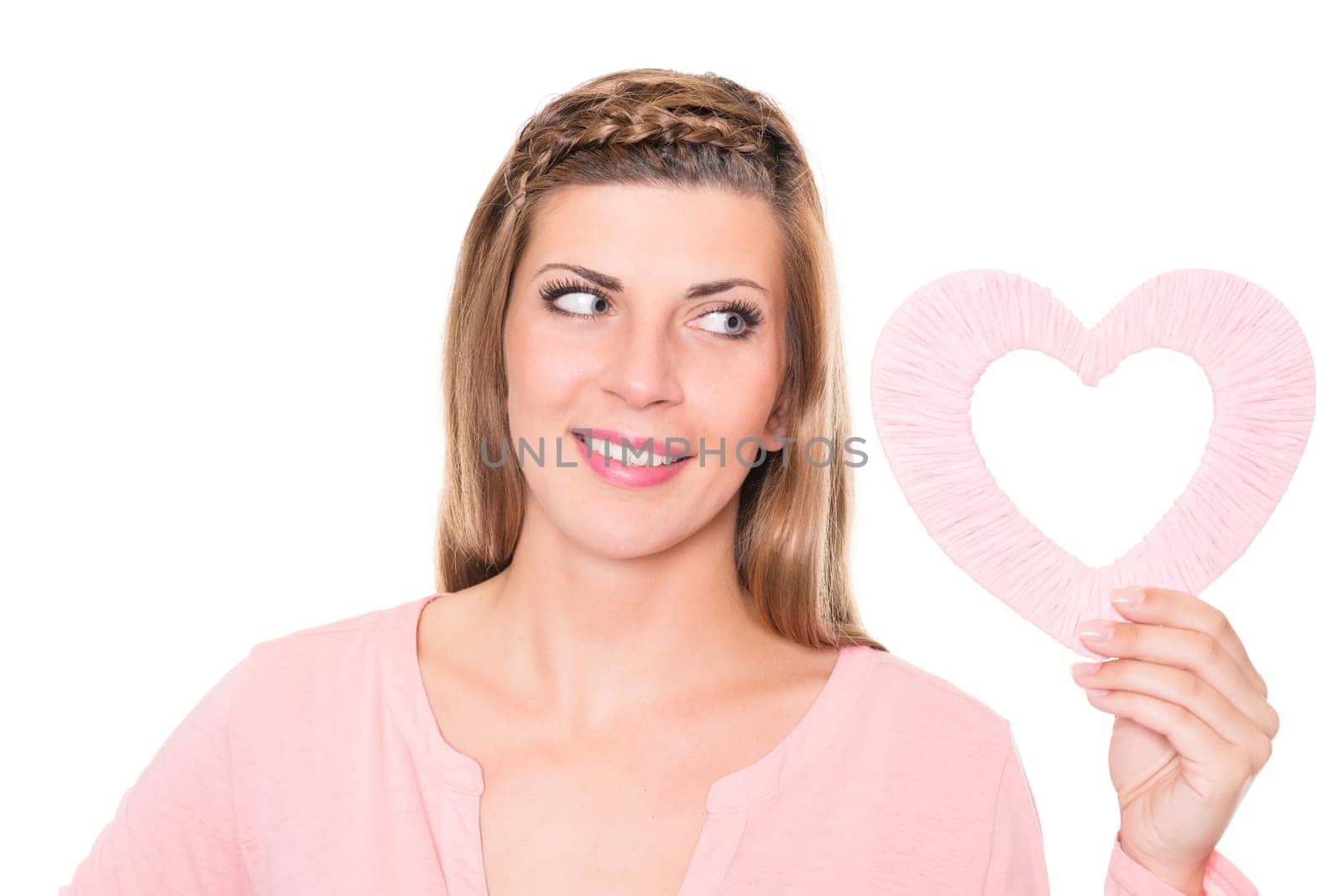 Portrait of a young woman with a pink heart against a white background