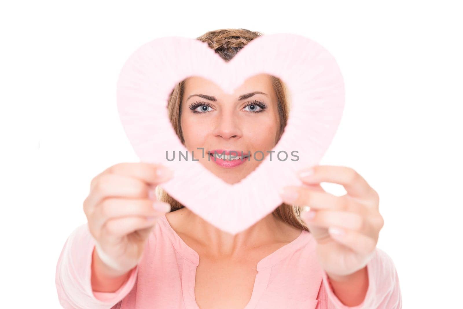 Portrait of a young woman with a pink heart against a white background