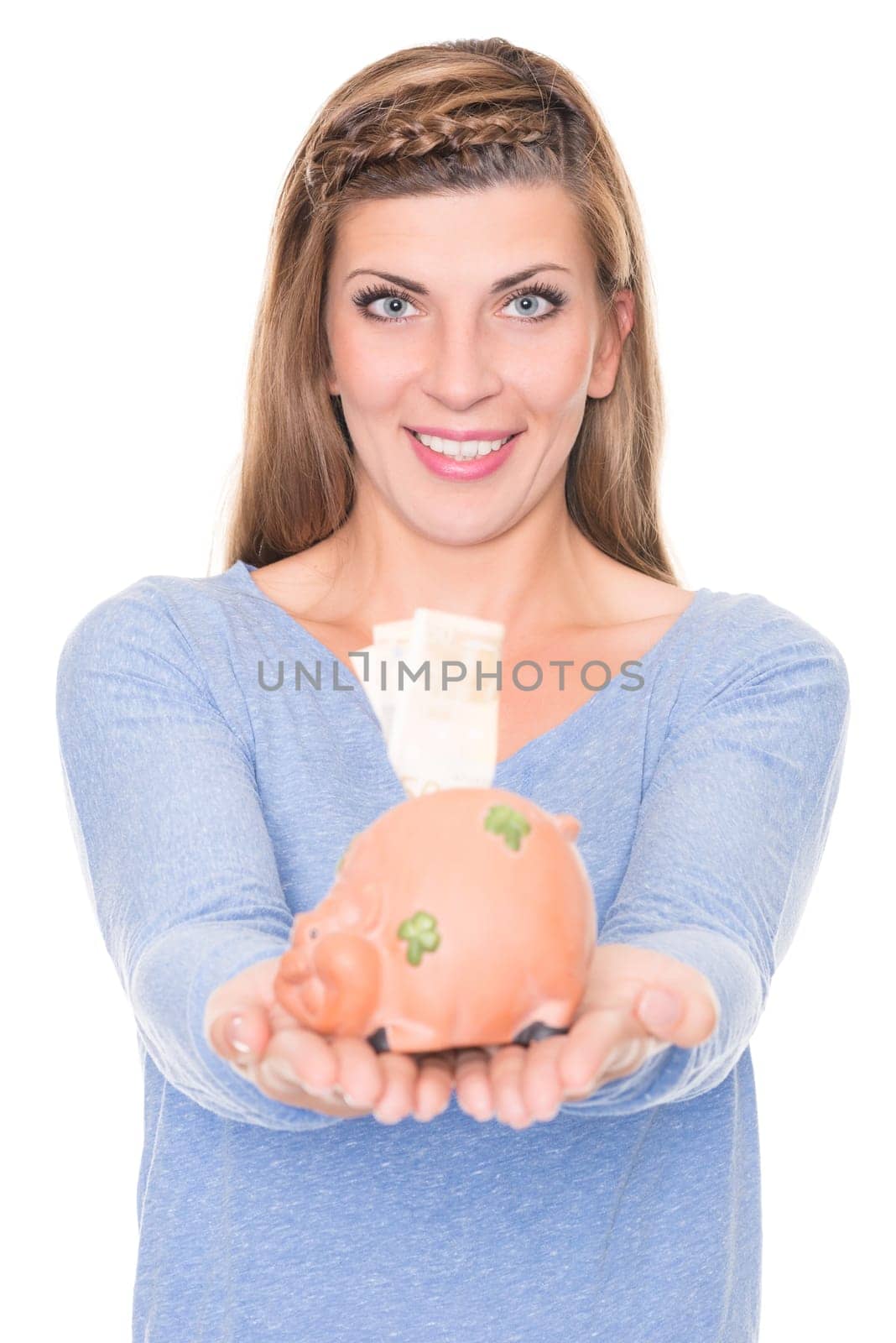 Portrait of a young woman with a piggy bank against a white background