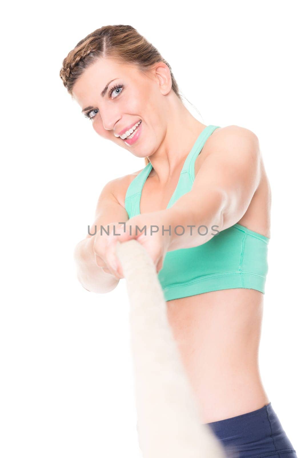 Studio recording of a young woman during the tug-of-war against a white background