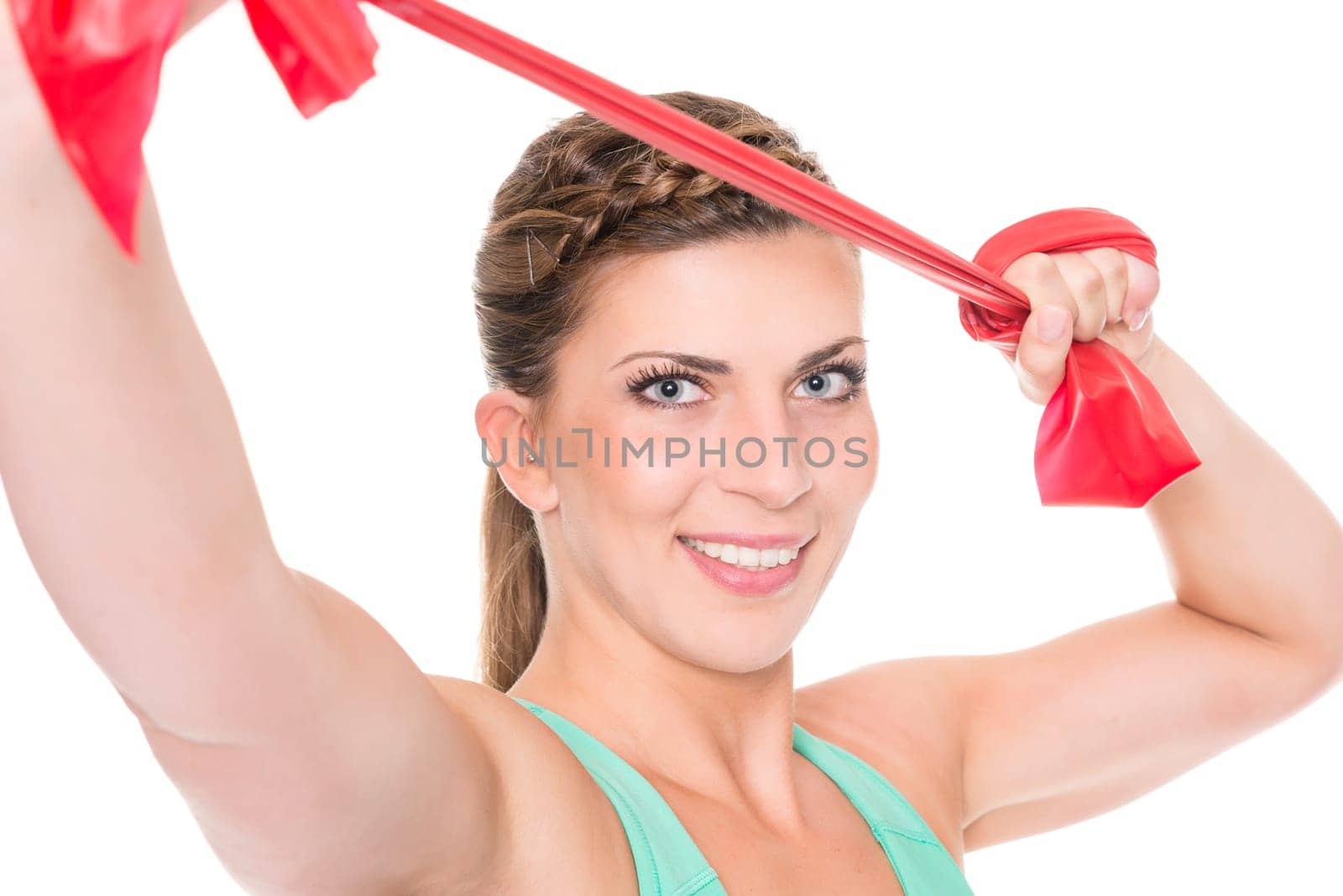 Studio recording of a young woman with a red gymnastics band against a white background