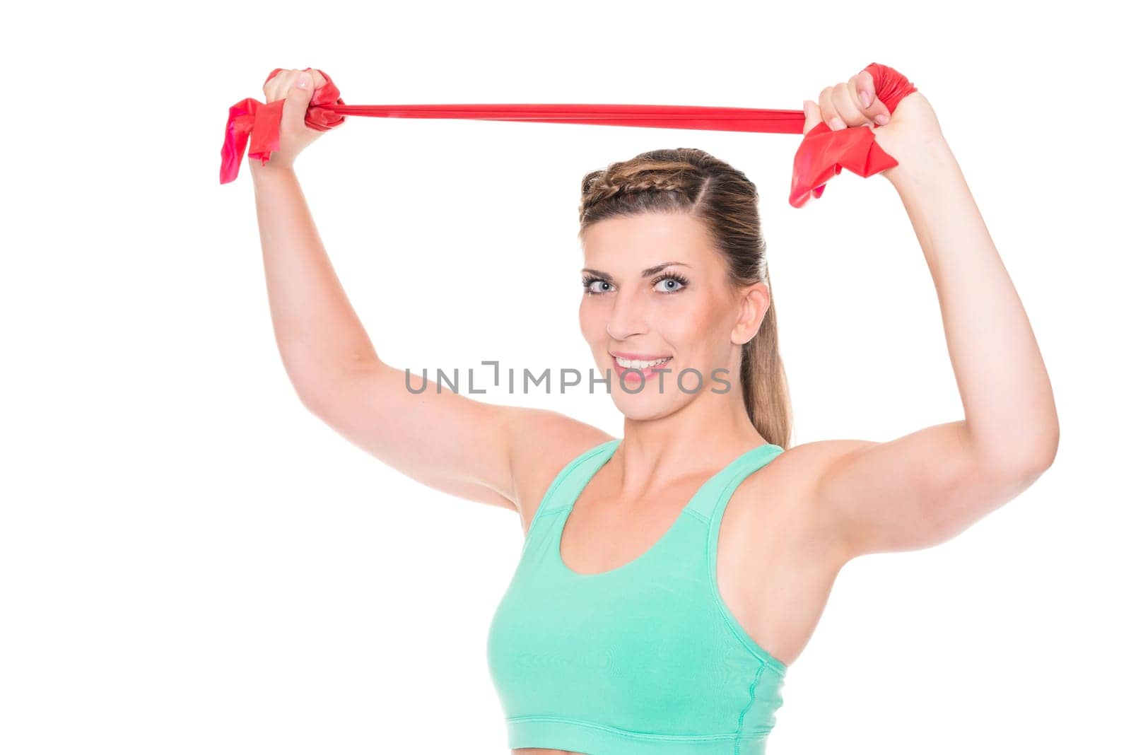 Studio recording of a young woman with a red gymnastics band against a white background