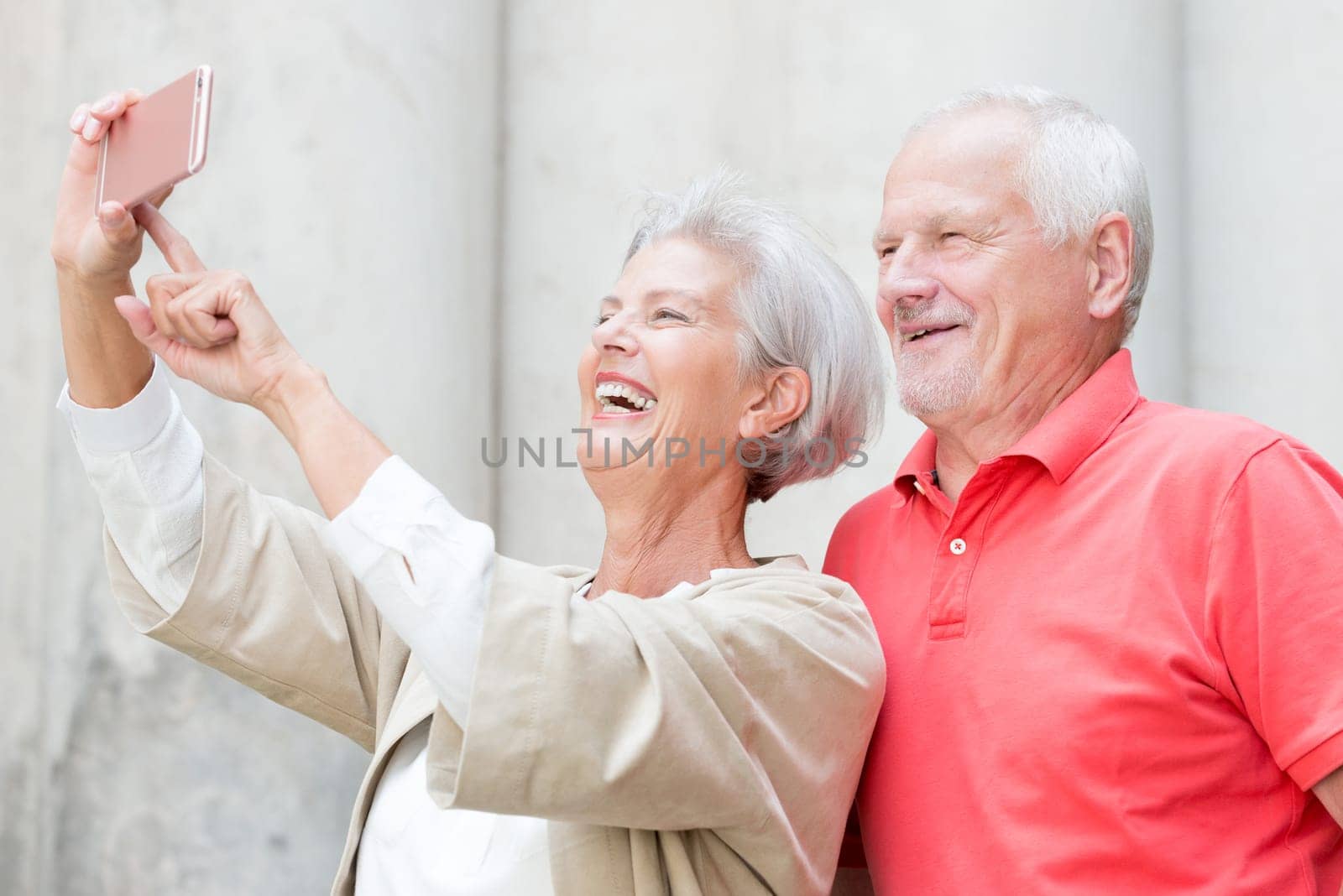 Two smiling seniors take a selfie