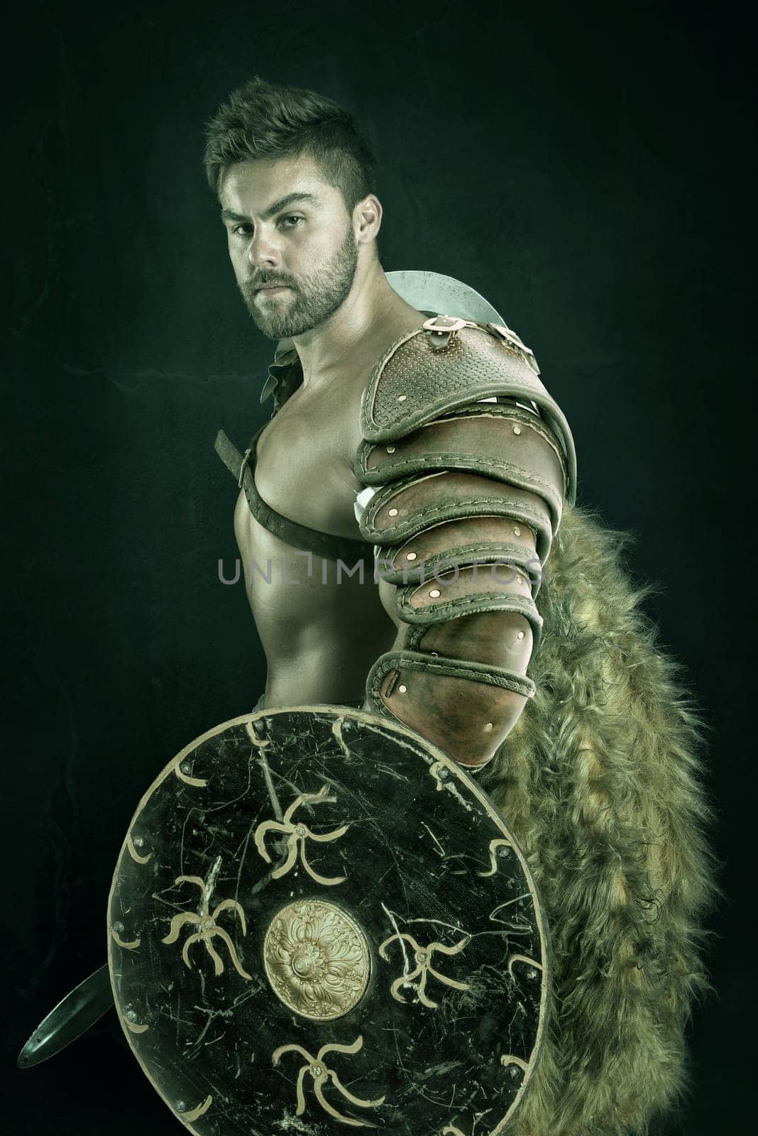 Ancient warrior or Gladiator posing over a dark background