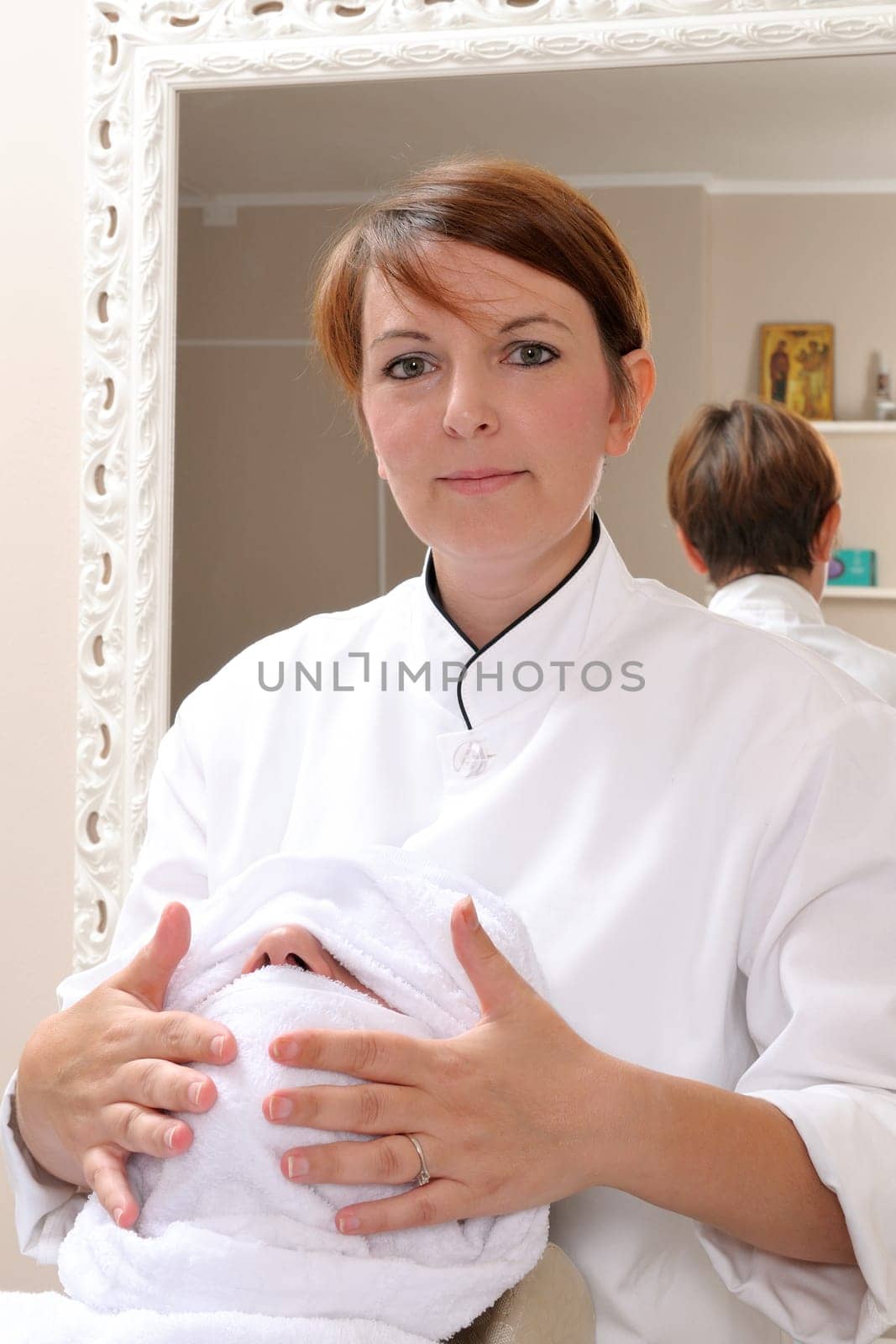 Shaving at the barber of a young boy in retro style with razor and shaving soap