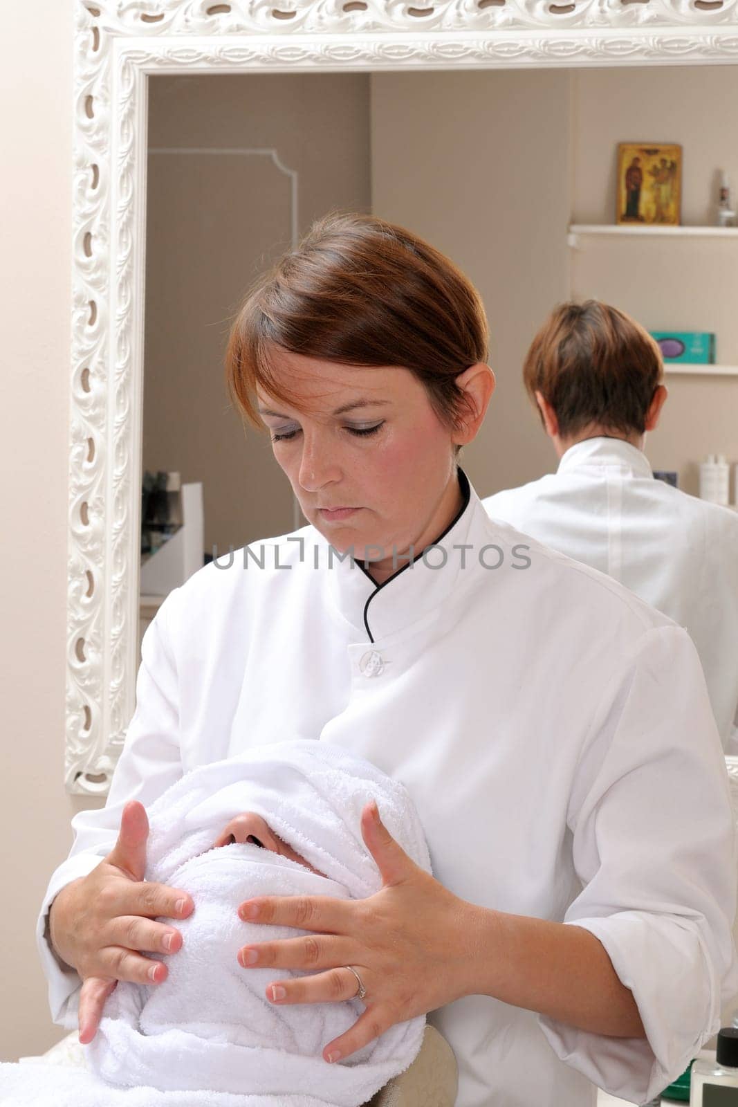 Shaving at the barber of a young boy in retro style with razor and shaving soap