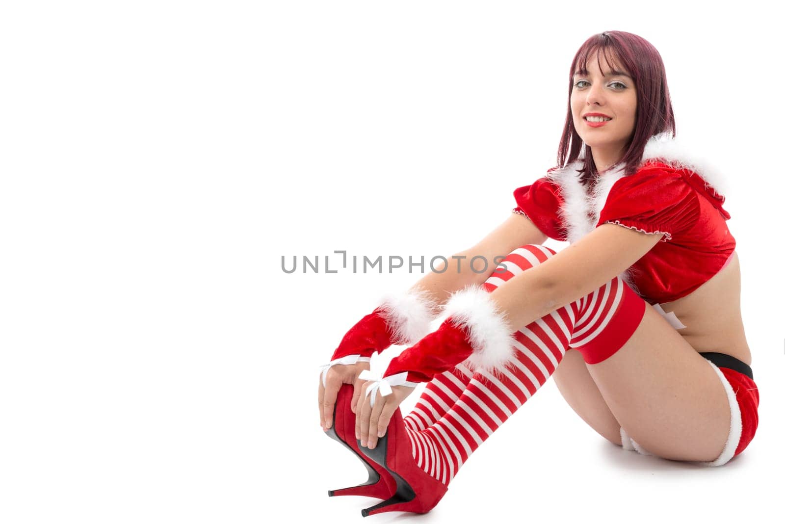 a portrait of beautiful  girl wearing santa claus clothes