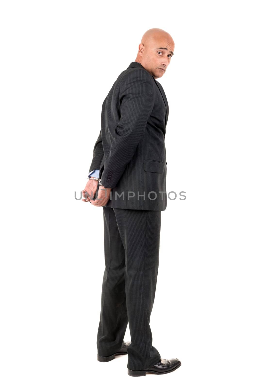 Businessman in handcuffs isolated in white background