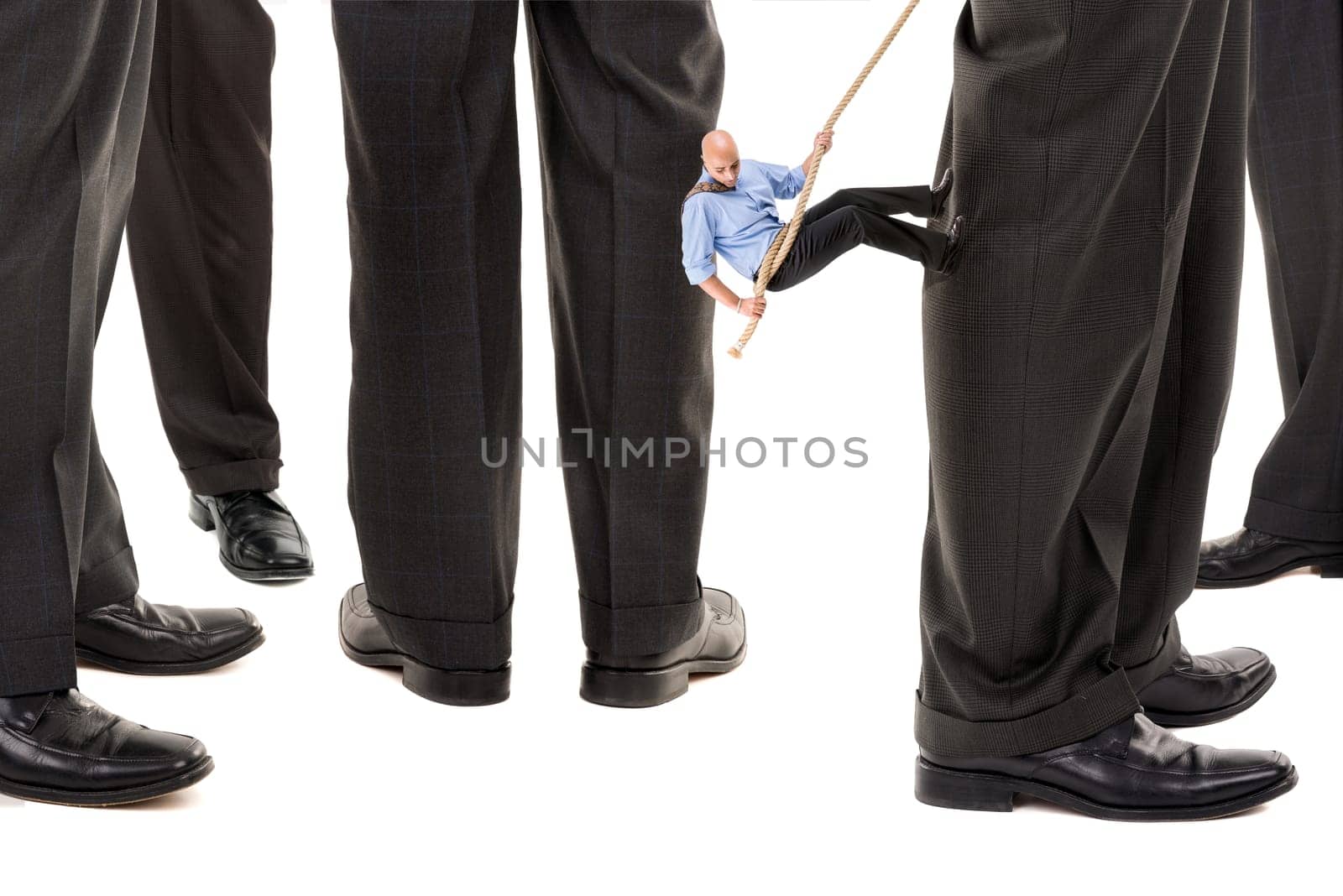 Small businessman climbing big business player's leg