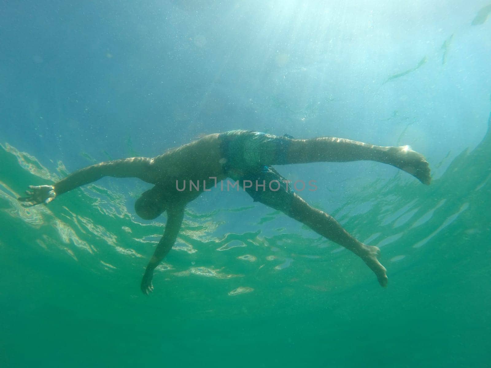 Man drowning viewed from below underwater