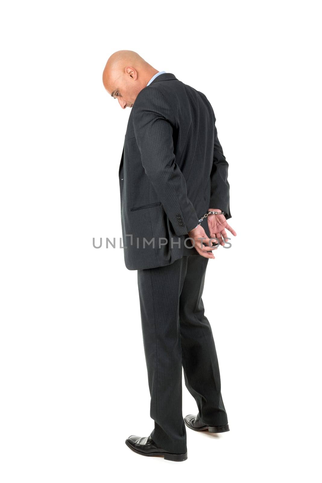 Businessman in handcuffs isolated in white background