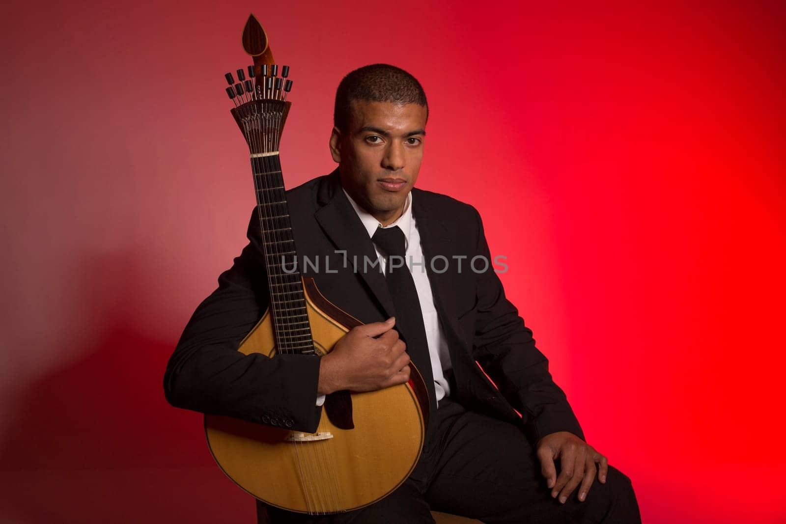 fado musician with a portuguese guitar, studio