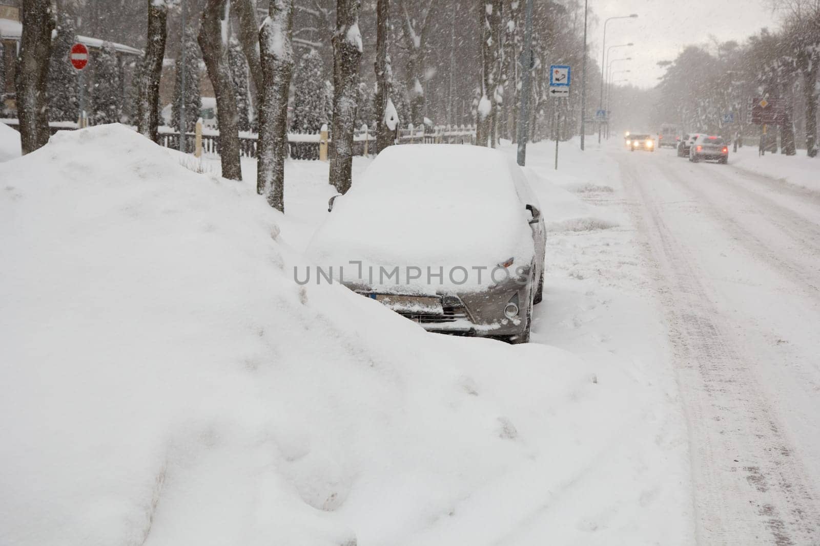 A parked car fully covered in snow