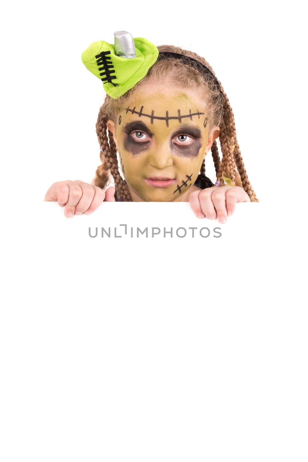 Girl with face-paint and Halloween monster costume over a white board