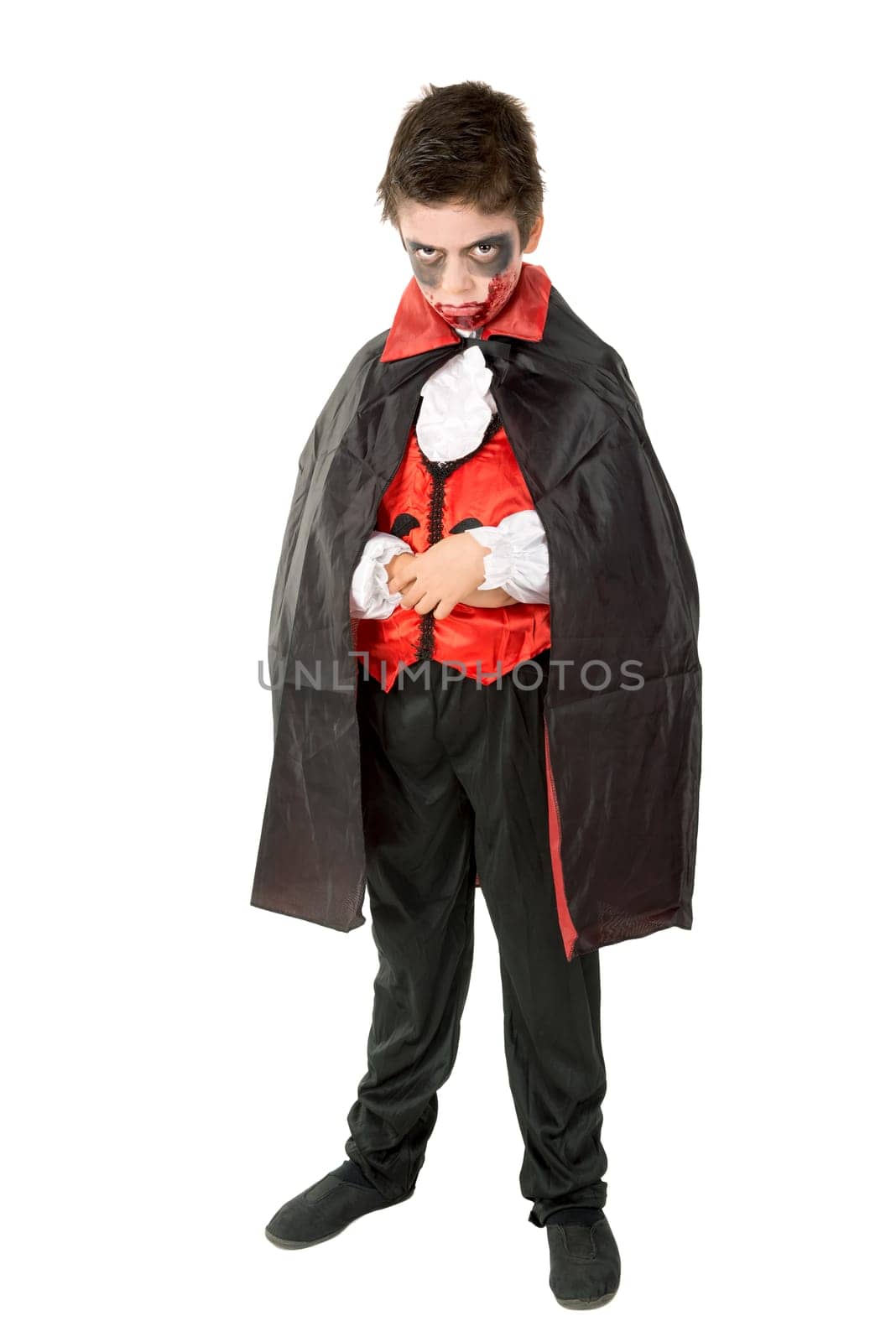 Boy with face-paint and vampire Halloween costume isolated in white