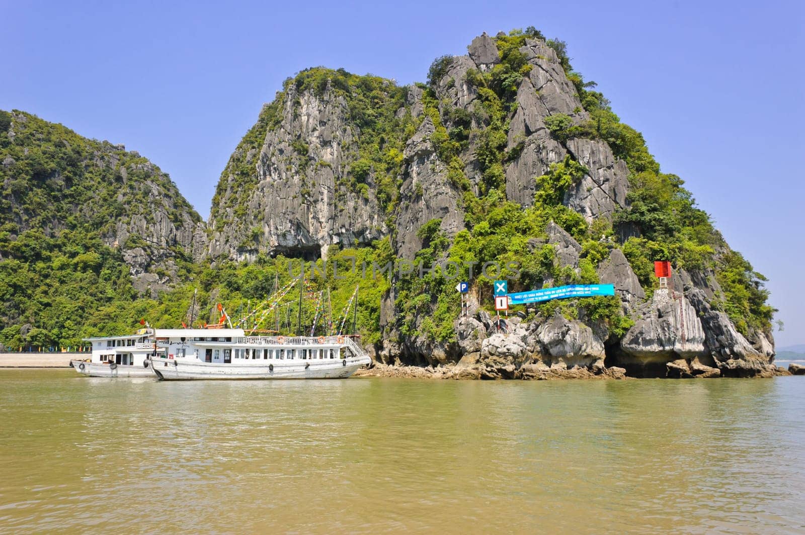 Tourist boats at Dau Go cave in Halong bay, Vietnam