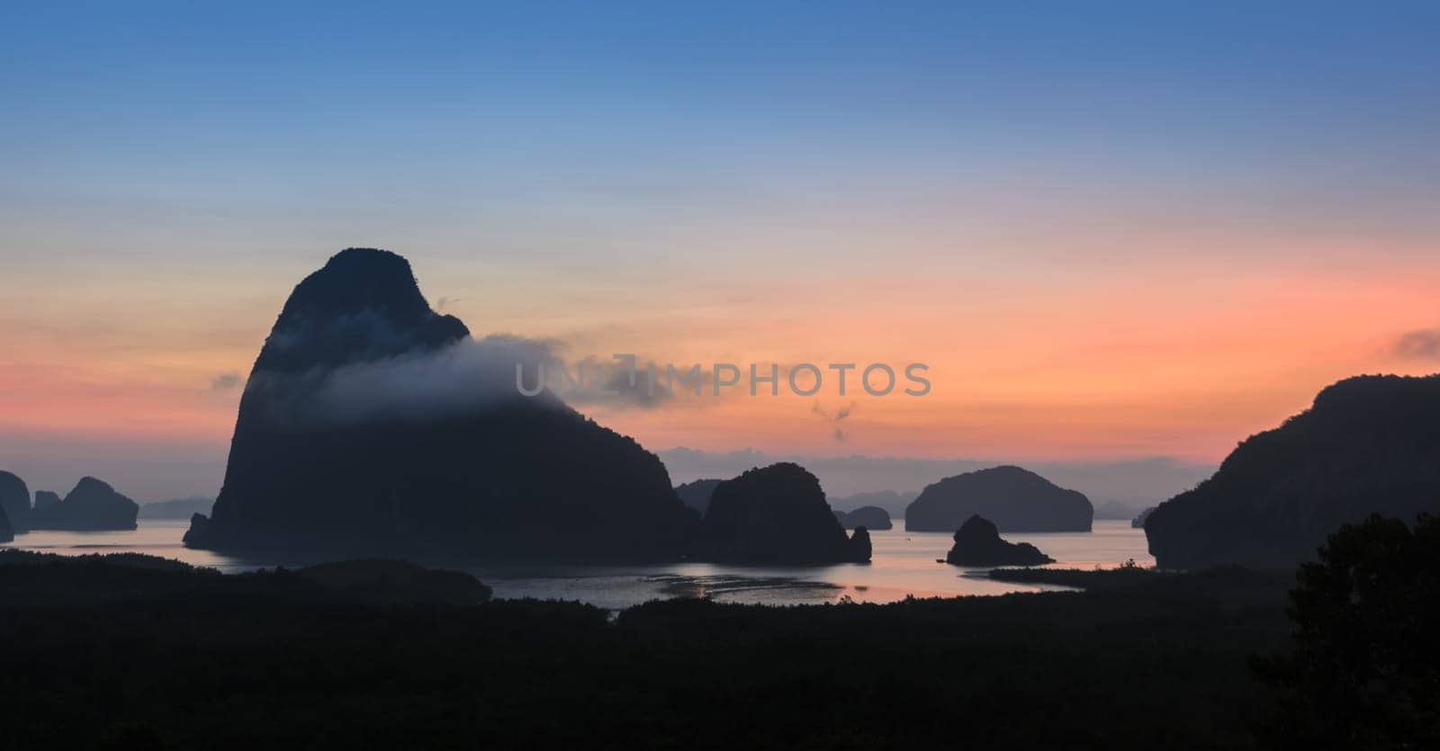 Landscape of limestone karsts in Phang nga bay at sunrise. Unseen place of "Samed Nangshe"" or ""Samet Nangchee"" in Phang Nga province, Thailand."