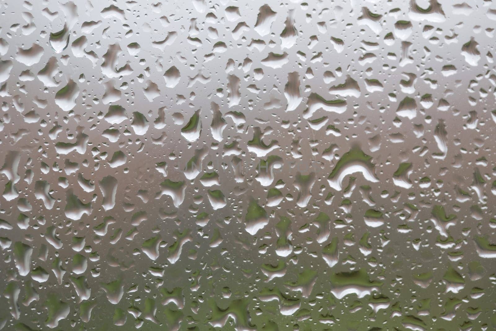 Glass surface with water drops in a rainy day