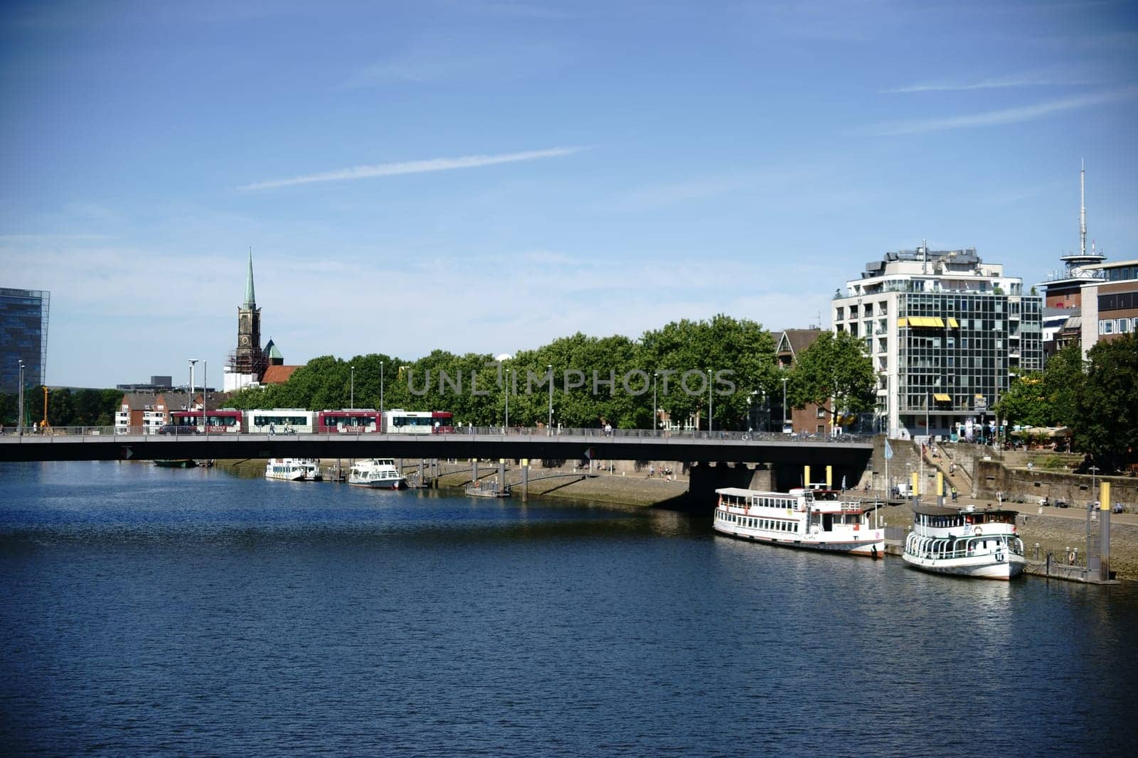 The view over the river Weser and the city of Bremen with buildings and infrastructure.