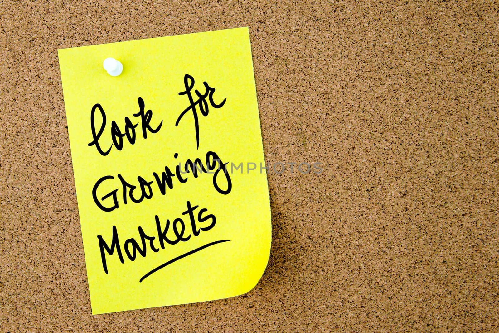 Look For Growing Markets text written on yellow paper note pinned on cork board with white thumbtack. Business concept image with copy space available