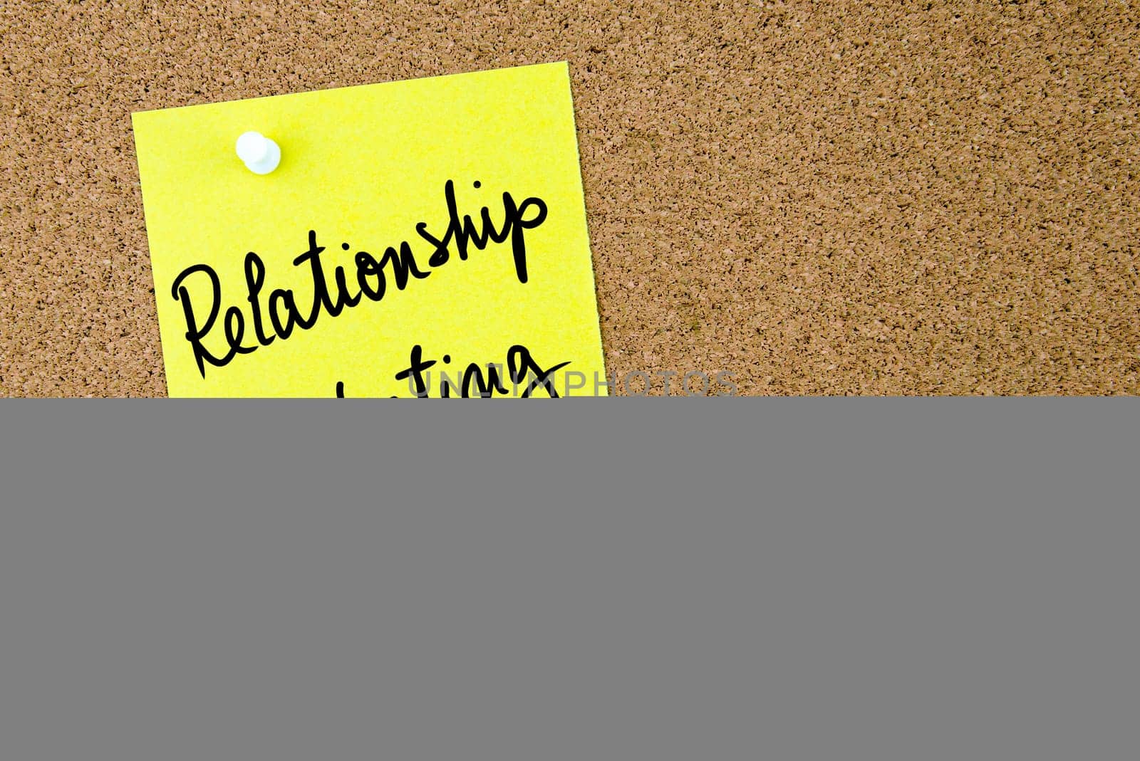 Relationship Marketing text written on yellow paper note pinned on cork board with white thumbtack. Business concept image with copy space available