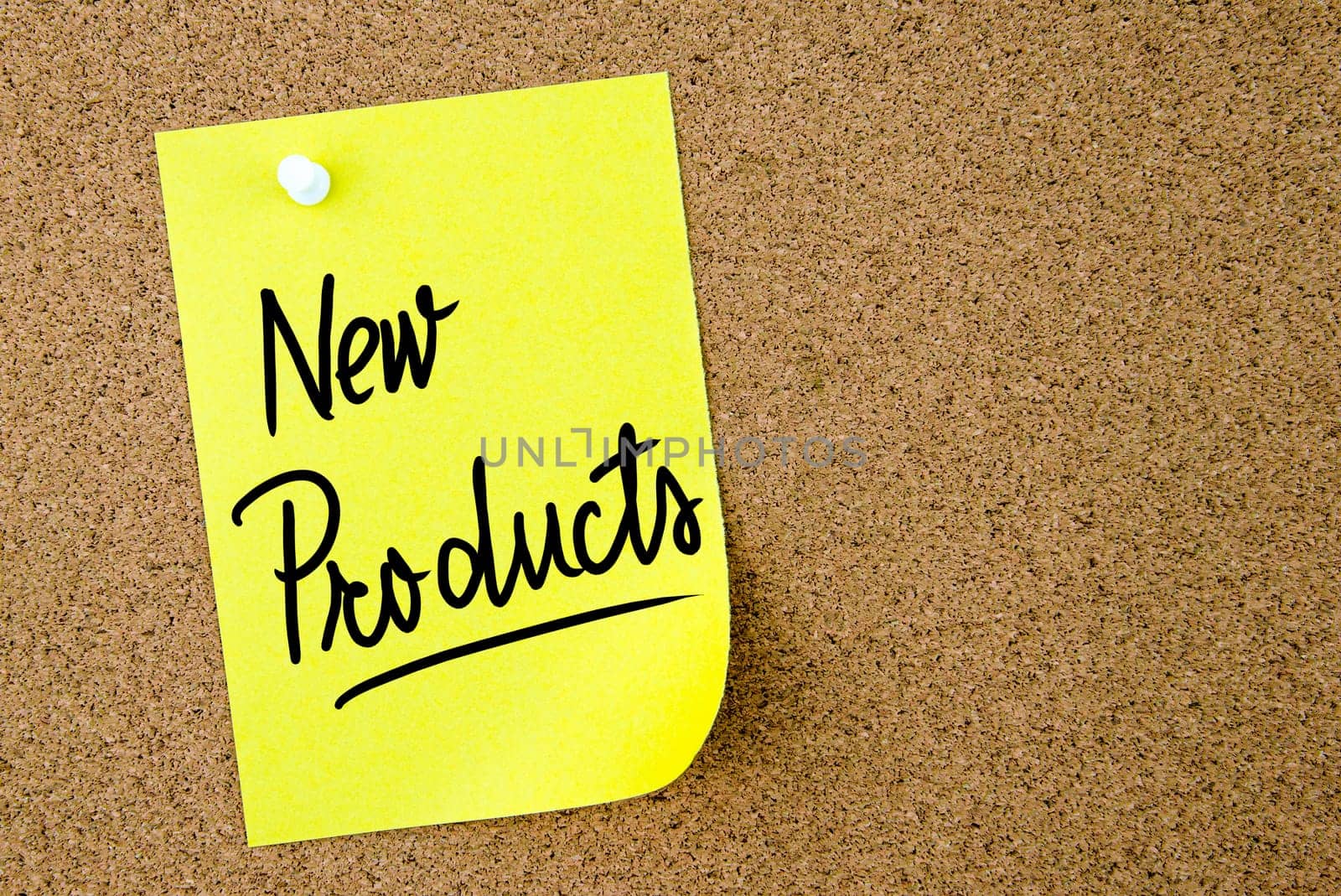 New Products text written on yellow paper note pinned on cork board with white thumbtack. Business concept image with copy space available